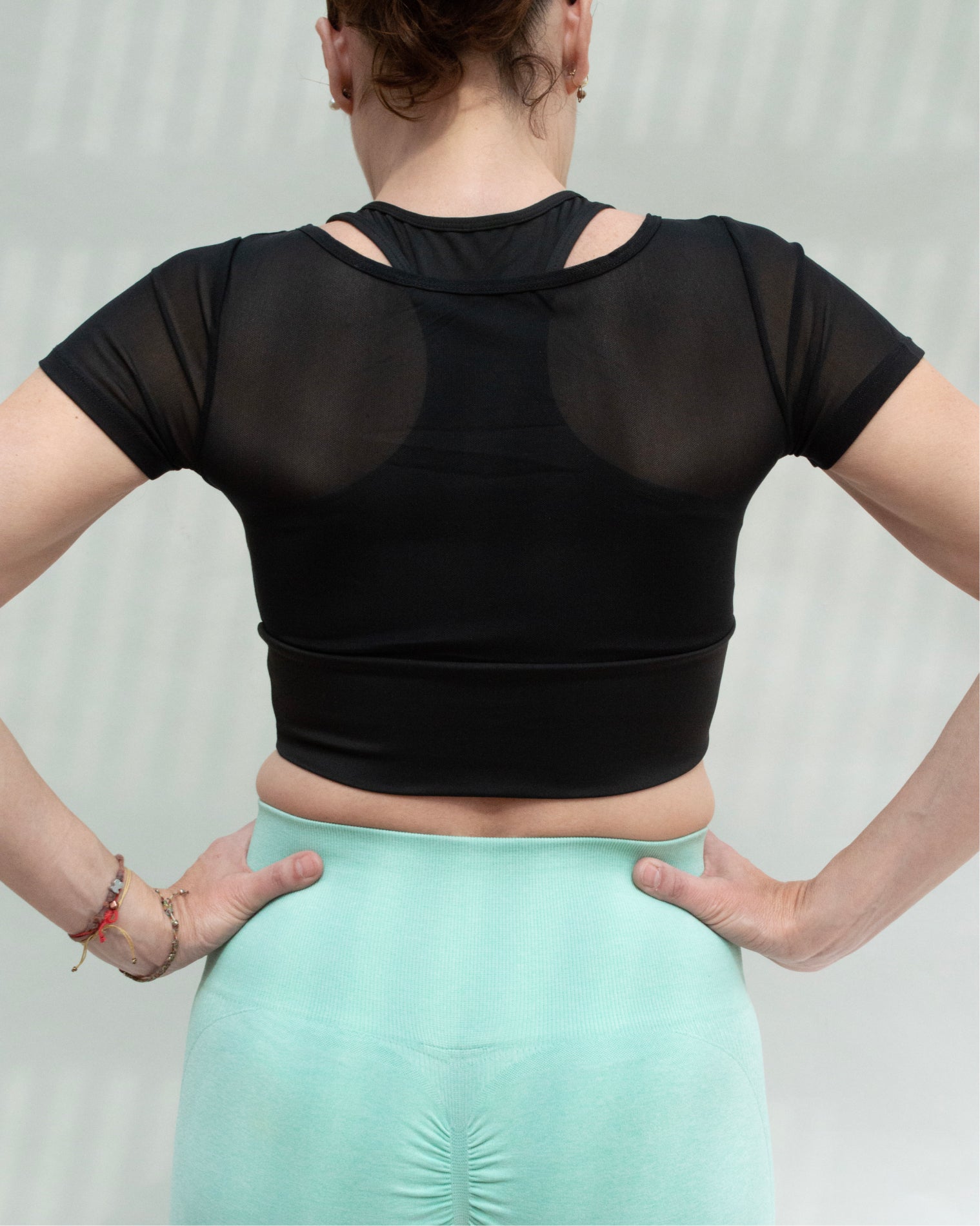 Blusa deportiva de manga corta para mujer con paneles de mesh transpirable, diseño ligero y ajuste cómodo, soporte ligero a medio y tela suave que se adapta al cuerpo, ideal para entrenamiento y uso activo diario.