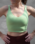 Top deportivo verde tipo tank para mujer, con tirantes anchos y escote redondeado, mayor cobertura en el pecho y ajuste ceñido al cuerpo. Diseño liso de estilo deportivo, ideal para entrenar o usar en actividades diarias.